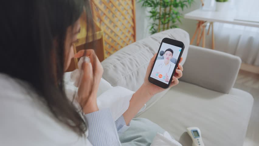 Asian young woman patient talking virtual online with medical doctor. Attractive physician man giving telehealth telemedicine video call for internet consult diagnosis treatment to sick girl at home.