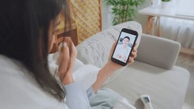 Asian young woman patient talking virtual online with medical doctor. Attractive physician man giving telehealth telemedicine video call for internet consult diagnosis treatment to sick girl at home. - Powered by Shutterstock - Get 15% off with code: PIKWIZARD15