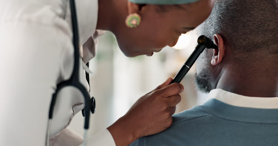 Doctor, otoscope and healthcare with people in clinic for ent results, ear exam and medical expert. Helping, appointment and support with patient in hospital for diagnosis, physician and feedback