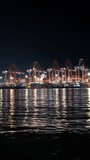 Gantry cranes at cargo container terminal in the night. Vertical timelapse of sea cargo port - Powered by Shutterstock - Get 15% off with code: PIKWIZARD15