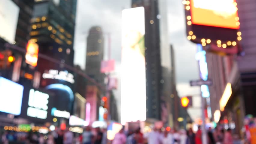 New York City Times Square, Manhattan Midtown Broadway street, USA. American NYC urban life. Defocused people pedestrians. Advertising signs, commercial ads, illuminated billboard screens glowing.