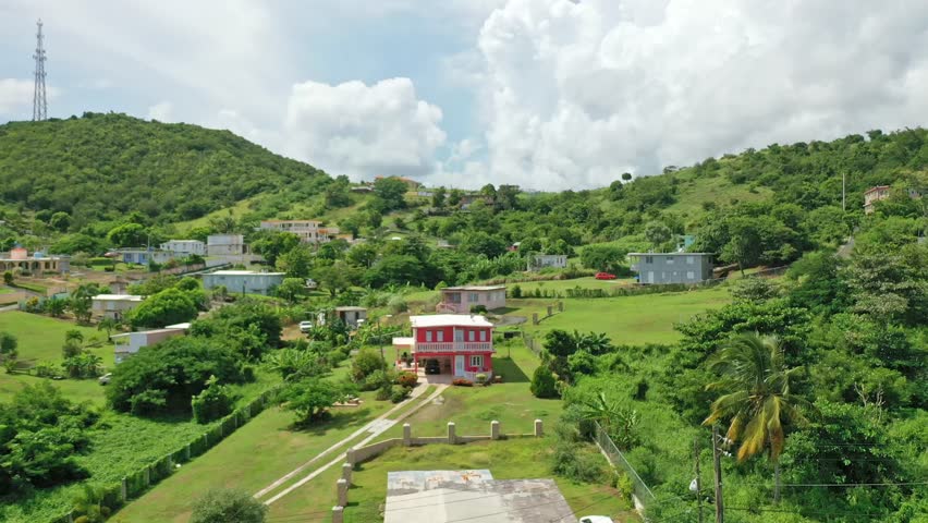 A drone footage showing Punta Tuna Natural Reserve and rural houses in Maunabo, Puerto Rico with cloudy sky