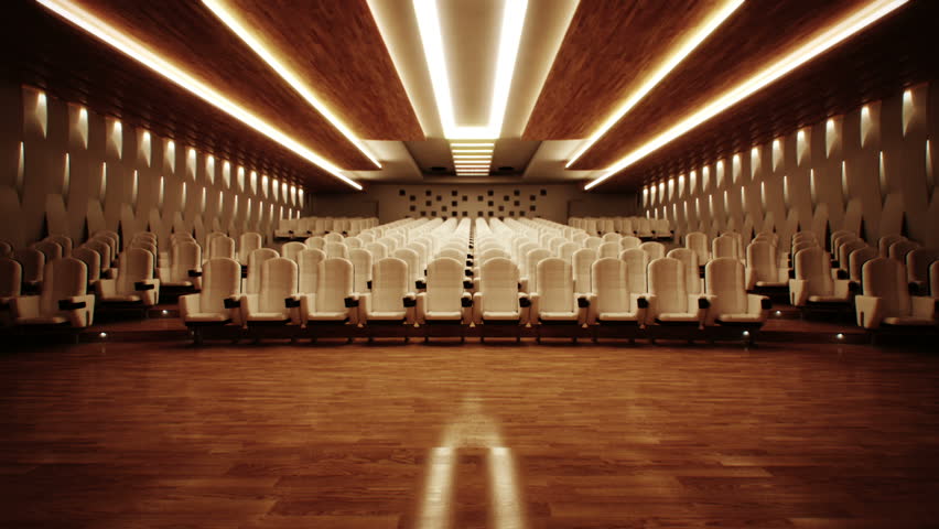 Large empty cinema with comfortable leather seats.