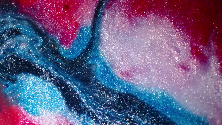 Vibrant red, blue, and white substances blending in a sparkling close-up macro shot