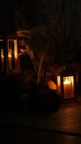 Dark room with candles, spiders, webs and a human skull. Horrible atmosphere of horror, ghosts, spirits and scary stories. Halloween decorations