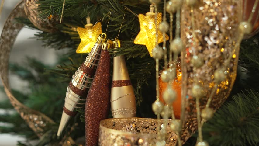 Close-up of Christmas tree with many golden ornaments. Luxury decoration. 4k.