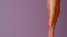 Stack of three Donuts Stop motion animation on female hand. Pink Doughnut with white sprinkles on pastel light purple background. Colorful Food animation. Concept of tasty but unhealthy snack. - Powered by Shutterstock - Get 15% off with code: PIKWIZARD15