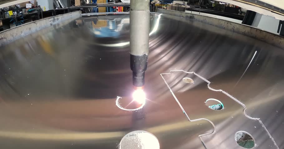 Plasma cutting. Plasma cutter work at the factory. The plasma cutter will cut the part. The process of cutting a metal part with a plasma cutter