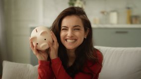 Happy excited laughing Caucasian rich business woman female girl delighted businesswoman shaking piggy bank full of money saving finance wealth cash successful investment deposit currency inside home - Powered by Shutterstock - Get 15% off with code: PIKWIZARD15