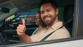 Family trip Caucasian happy woman female girl sitting inside new car with male man fasten automobile seat belt test drive safety protection guy looking camera showing thumb up recommend rental service - Powered by Shutterstock - Get 15% off with code: PIKWIZARD15