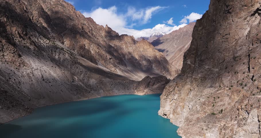 Aerial Pullback Above Attabad Lake, Hunza Valley, Pakistan. Summer in Pakistan. Bright Blue Lake, Majestic Mountain Landscape