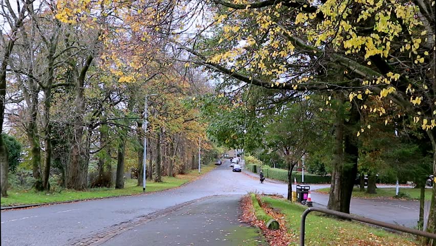 Surburban streets of Glasgow, Scotland during a pleasant autumn (fall) afternoon. Trees are vibrant with colourful leaves and foliage 