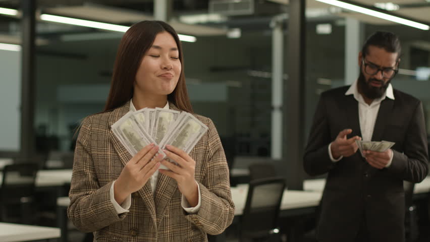Unequal salary inequality wage discrimination Asian woman rich business girl businesswoman hold big money banknotes female office envy jealousy Indian businessman man male guy shock little finance
