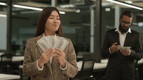Unequal salary inequality wage discrimination Asian woman rich business girl businesswoman hold big money banknotes female office envy jealousy Indian businessman man male guy shock little finance - Powered by Shutterstock - Get 15% off with code: PIKWIZARD15