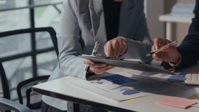 Business professionals collaborate in an office setting, analyzing financial reports and discussing strategies for success - Powered by Shutterstock - Get 15% off with code: PIKWIZARD15