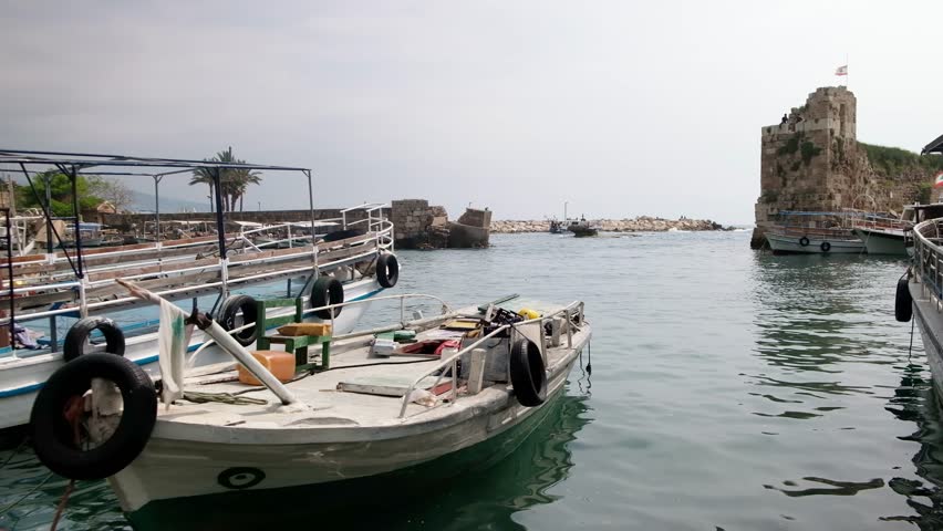 Boats rocking on waves in ancient Port of Byblos. Byblos ancient city, Jbeil, Lebanon