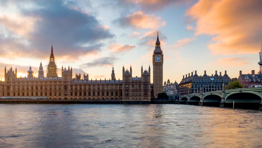 Long exposure sunset time lapse view of the Big Ben clocktower at Westminster Palace in London, England, during autumn time