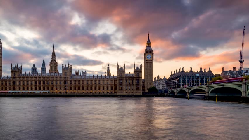 Long exposure sunset time lapse view of the Big Ben clocktower at Westminster Palace in London, England, during autumn time