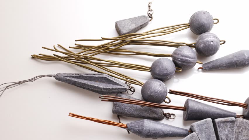 Old lead fishing sinkers on a white background. fishing tools.