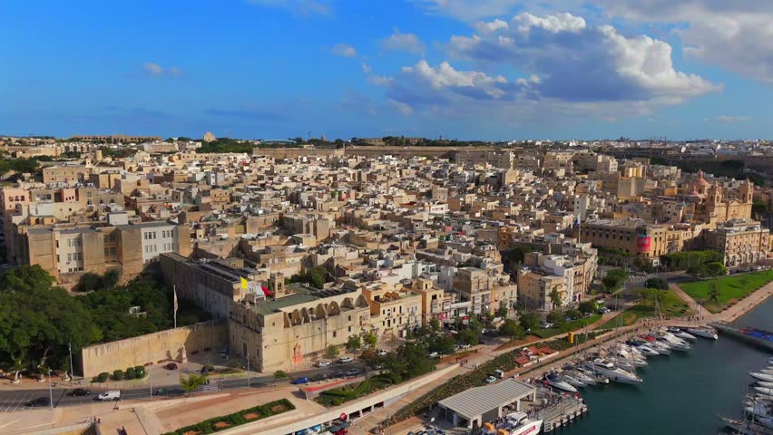 Birgu’s blend of medieval and baroque architecture is beautifully highlighted from above, nestled between the sea and its towering walls.