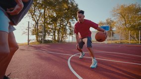 Young sportsmen improve defense technique for playing basketball at outdoor court. Active black man bounces ball trying to block partner stealing ball - Powered by Shutterstock - Get 15% off with code: PIKWIZARD15