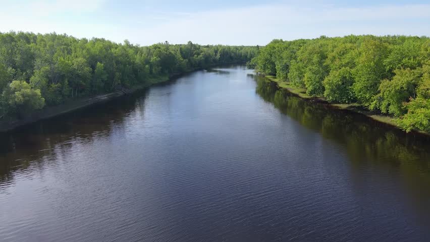 Flying over a very winding river and forest in Northern Minnesota near the border of Canada
