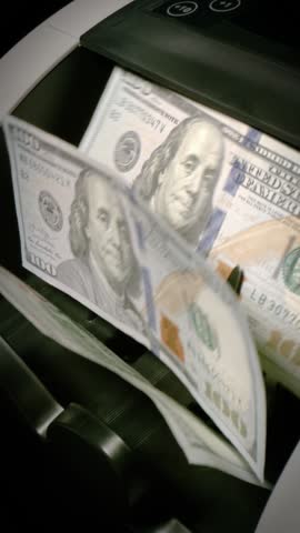 Money counting machine. Currency counting machine counting in slow motion. Vertical Video.