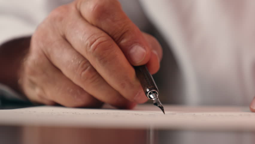 Close up old male hand holding fountain pen writer writing letter man paper business calligraphy businessman unrecognizable deal signing document paperwork signature contract vintage ink detailed text