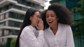 Asian Korean Chinese African American women businesswomen whisper secret gossip laughter colleagues coworkers workers girls females conversation business chatting news talk friendship fun enjoy city - Powered by Shutterstock - Get 15% off with code: PIKWIZARD15