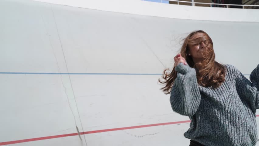 A joyful woman in a cozy sweater dances with vibrant energy 4k