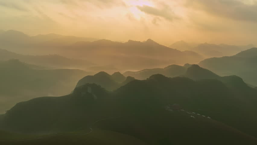 Drone aerial view Hyperlapse of landscape mountains view with fog flowing over mountains,High angle view clouds over countryside at northern Vietnam