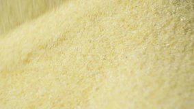 Uncooked semolina cereal pouring on black background slow motion - Powered by Shutterstock - Get 15% off with code: PIKWIZARD15