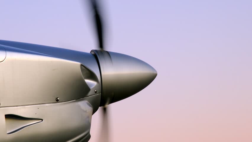 The propeller of a single-engine light aircraft spins and stops. Aircraft engine shutdown after flight