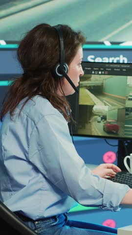 Vertical Video Diverse team of employees monitoring delivery trucks routes around the city with map and surveillance footage. People working with gps coordinates for tracking orders, cargo logistics