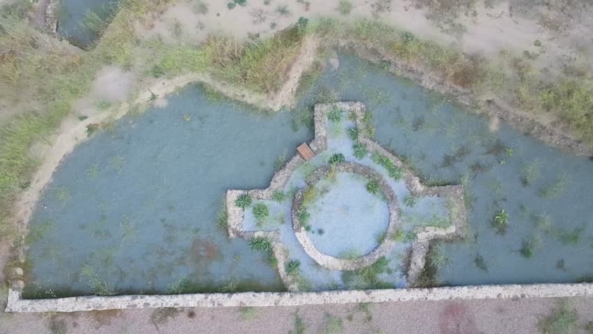 Filmed by a drone with a top-down view of a Roman villa seeing its striking bathing area and by raising the camera and moving the drone backwards we discover the environment in which it is located