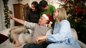 Merry Christmas, happy family calling by video to relatives or taking photo. People and modern technology, celebration of traditional winter holiday together, family time in New year vacation - Powered by Shutterstock - Get 15% off with code: PIKWIZARD15
