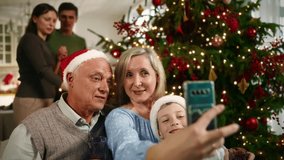 Family photo by mobile phone, grandparents and child boy taking selfie in Xmas. Happy new year and merry Christmas, cheerful people celebrating holidays with family, take pictures by modern smartphone - Powered by Shutterstock - Get 15% off with code: PIKWIZARD15