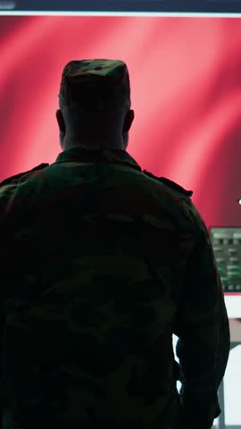 Vertical Video American army working in a command post with green screen, soldiers examining satellite imagery for clues regarding a national safety operation. US military control tower for