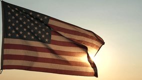 Veterans Day, Memorial Day. Silhouettes of American flag waving in the sky against sunset or sunrise background. Concept of US Holidays 4th of July, Independence Day, Veterans Day, Celebration, Labor - Powered by Shutterstock - Get 15% off with code: PIKWIZARD15