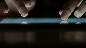 A person is using a tablet with their thumb and index finger. The tablet is on a table and the person is looking at it - Powered by Shutterstock - Get 15% off with code: PIKWIZARD15