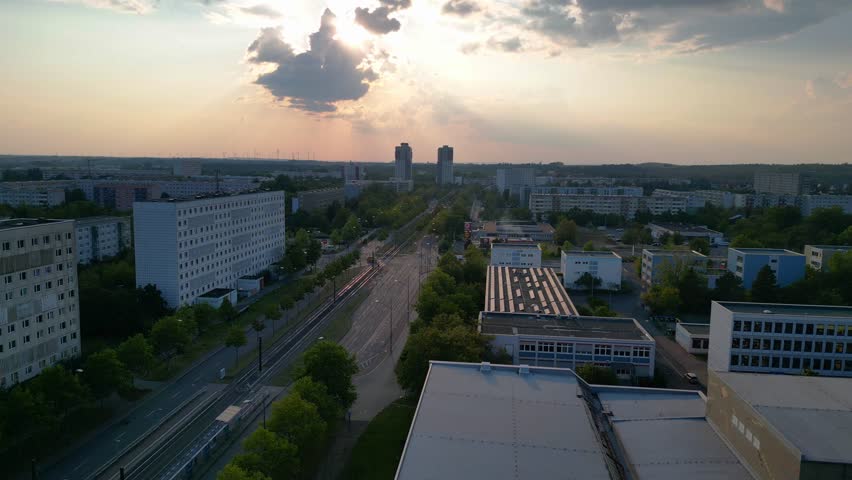 halle neustadt in germany, tramway station and the distinctive swimming pool building with its colorful mural. Magic aerial view flight descending drone