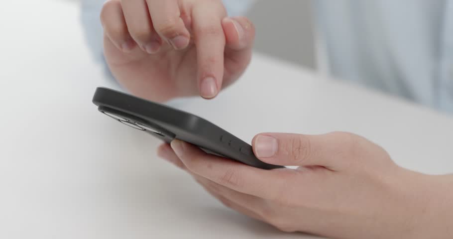 Close-up shot of a finger pressing the unlock button on a smartphone screen, capturing the precise moment of interaction and access to the device