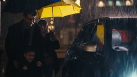 Young family of four under a yellow and blue umbrella walk in the rain by a running car, illuminated by city lights at night. Concept of family bond, protection, and rainy urban scenes. - Powered by Shutterstock - Get 15% off with code: PIKWIZARD15