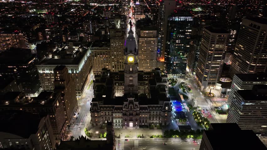 Aerial footage over North Broad Street panning forward and down over City Hall and Dilworth Park in Center City Philadelphia.