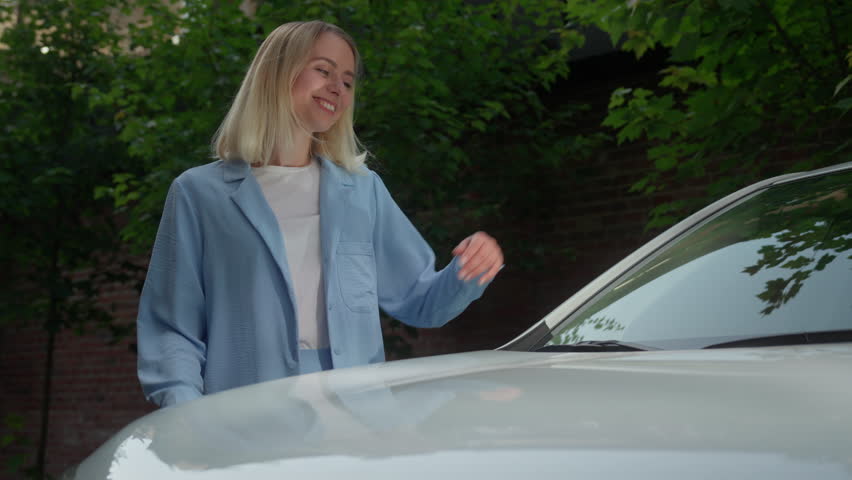 Smiling happy Caucasian woman lady touching hug automobile glad female driver girl lying hood businesswoman buying new transport in city car owner buyer celebrating purchase auto rent service vehicle