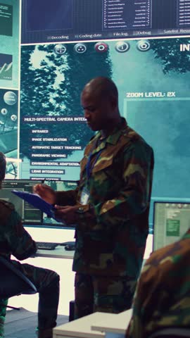 Vertical Video General headquarters under ruling of army IT professional that reviews insight about a new national safety mission. Command sergeant major briefing his marine corps troops with big data