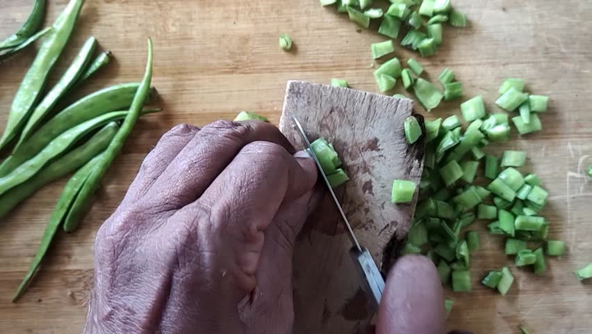 cluster beans cutting in wooden board