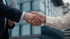 Close up unrecognizable multiracial business meeting in city colleagues Caucasian businessman man male guy African woman businesswoman girl female handshaking shake hands formal greeting hold folder - Powered by Shutterstock - Get 15% off with code: PIKWIZARD15