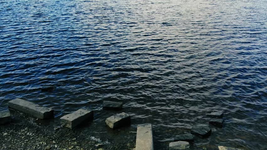 Reservoir lake of deep blue water drone aerial wide zoom shot selective focus