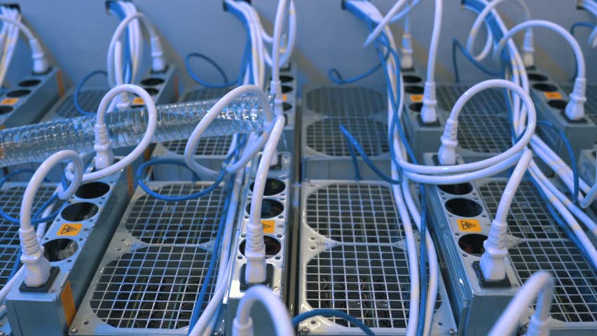 Advanced technology of immersion cooling of computers mining cryptocurrency in liquid for high efficiency in an open bath in a server room